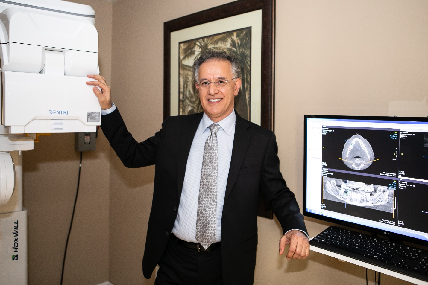 A dentist examining dental x-rays