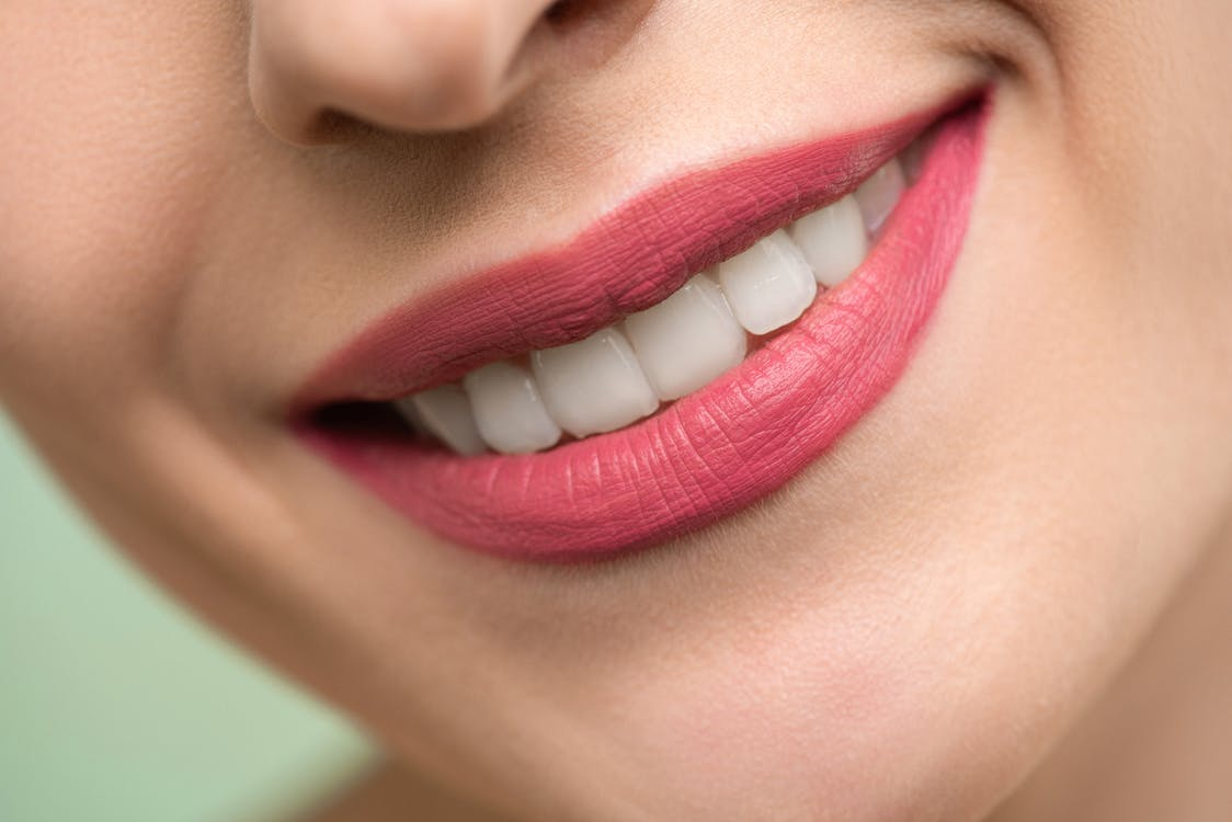 Close up of a person’s teeth’s shining through their smile