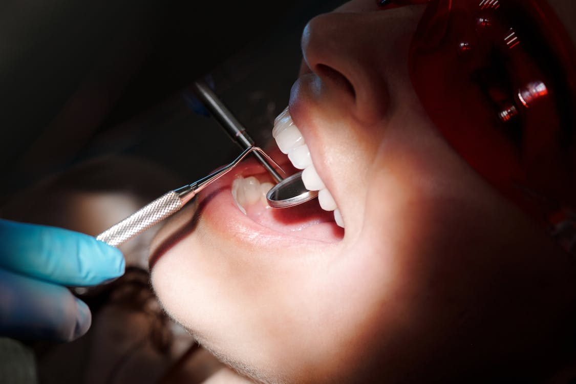 A person getting their teeth examined by a dentist
